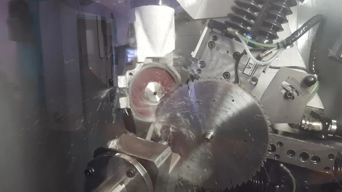 Circular saw blades packed in an open cardboard box with cardboard between the blades